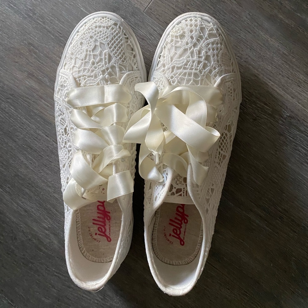 Lace sneakers with cream ribbon laces.